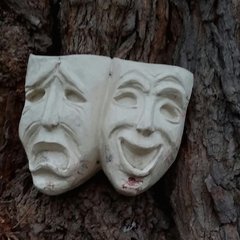 Two stone faces with different emotions
