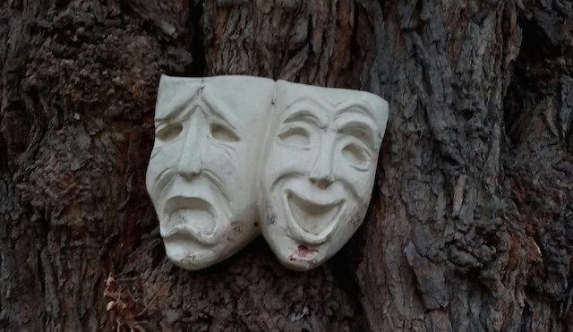 Two stone faces with different emotions